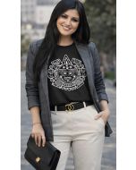 Smiling woman styling a black graphic top with a gray blazer, cream trousers, and a black handbag.