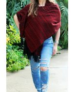 Model wearing a red woven rebozo shawl with black tassel details.
