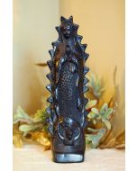 Full view of handcrafted black ceramic Guadalupe figurine with decorative backdrop
